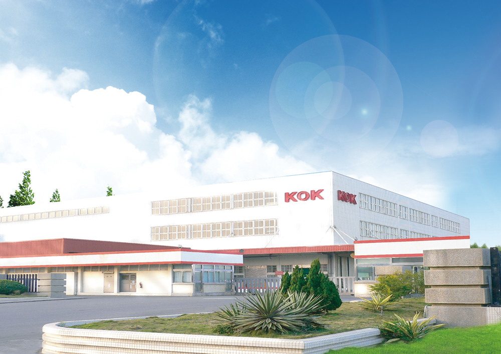 Kok facility for automotive parts on a sunny day