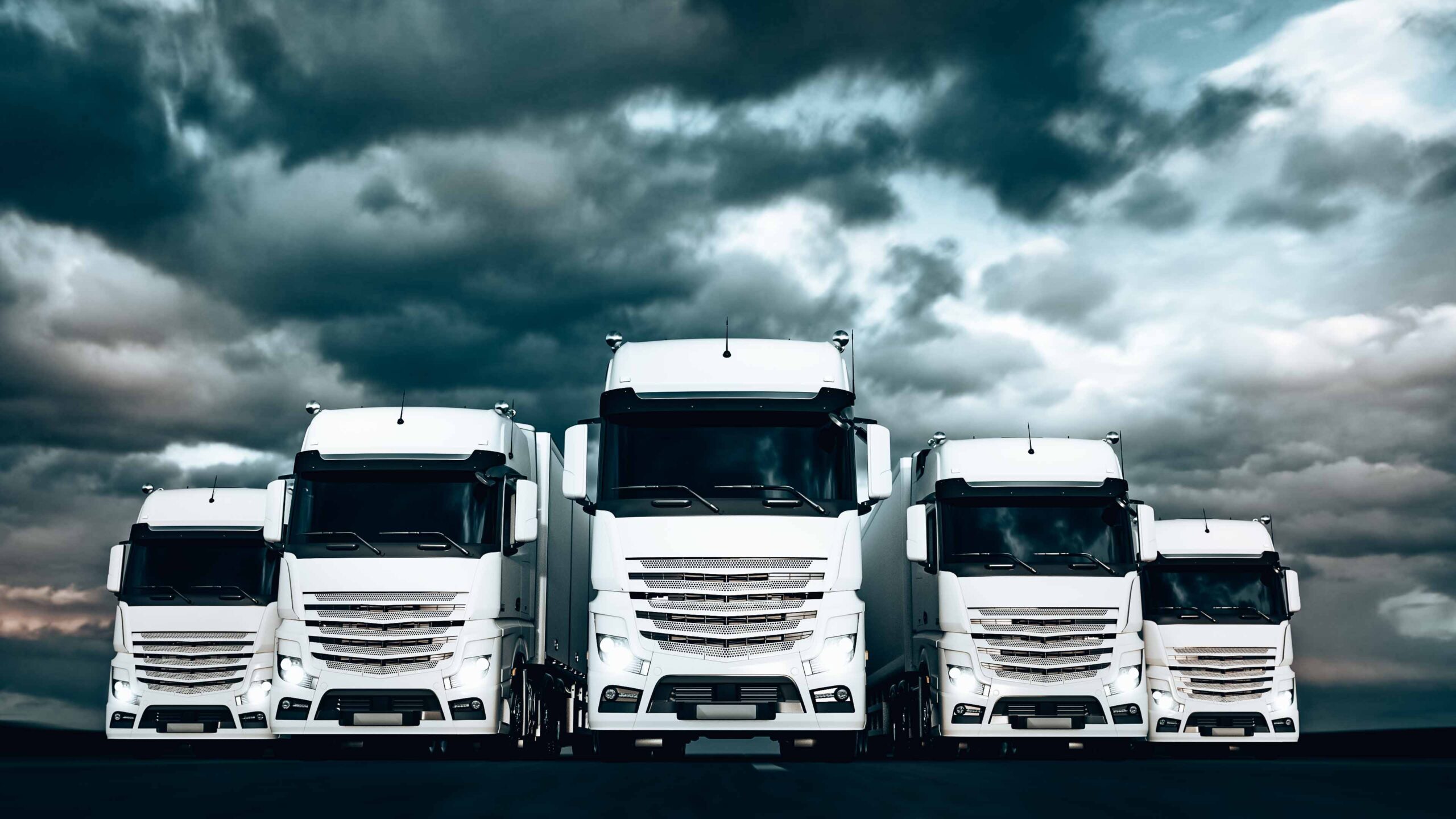 Fleet of white trucks on a stormy day